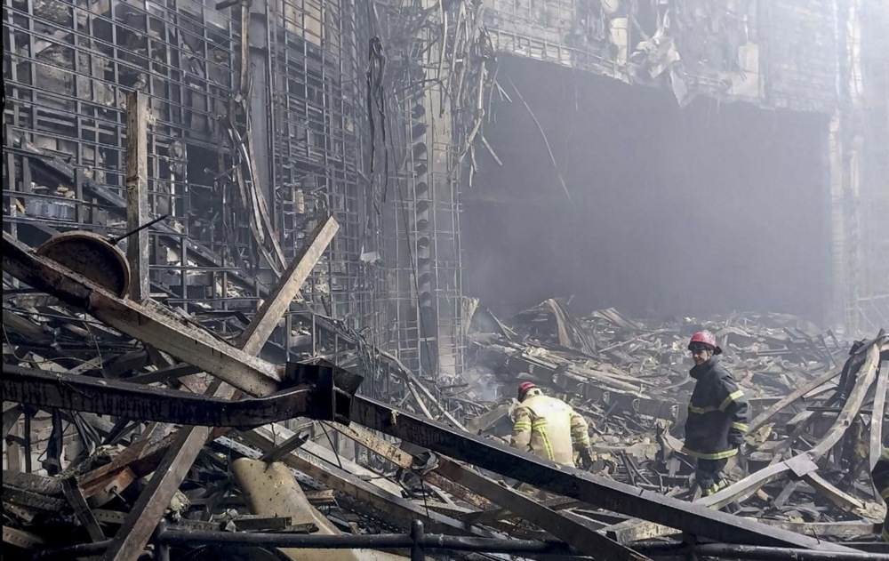 Russian rescuers clear the rubble and extinguish fires at Moscow's Crocus City Hall