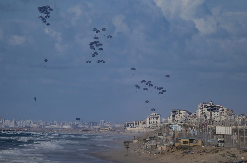 Humanitarian aid is air-dropped by US aircraft over northern Gaza Strip