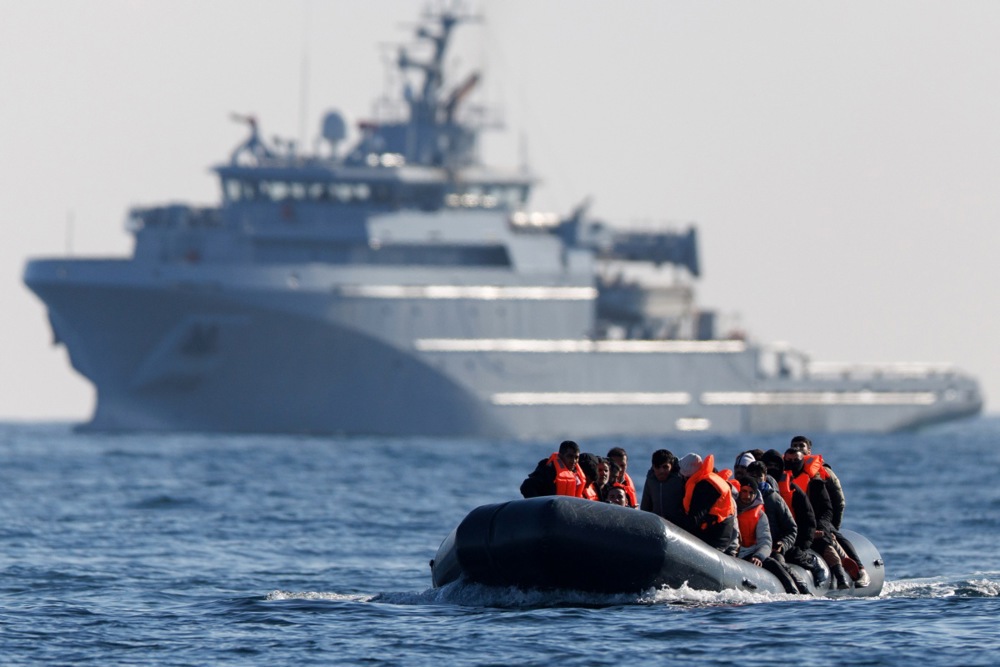 Migrants cross the English Channel on a small boat