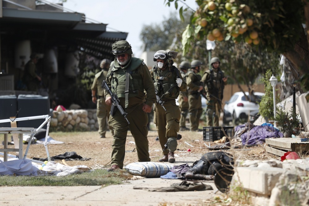 Israeli army remove bodies from Kfar Aza kibbutz