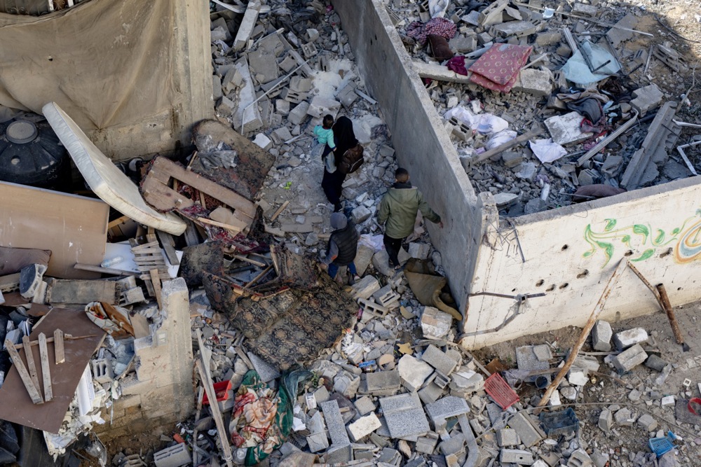 Palestinians mourn the dead and check destroyed homes after Israeli airstrikes on Rafah