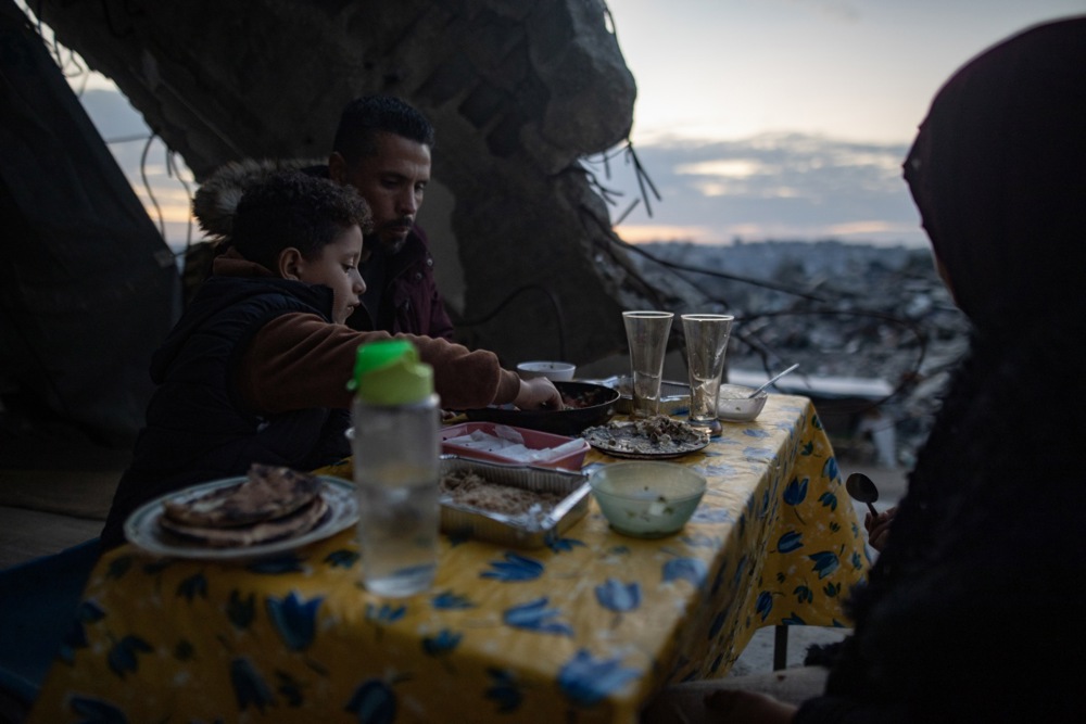 Palestinian family in Gaza gathers for Iftar between rubble of their destroyed home