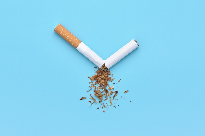 A broken cigarette with scattered tobacco for quit smoking concept.