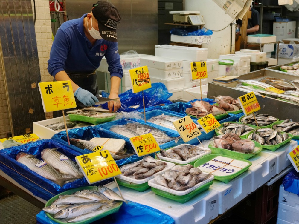 Shoppers examine seafood at a fish store in Tokyo