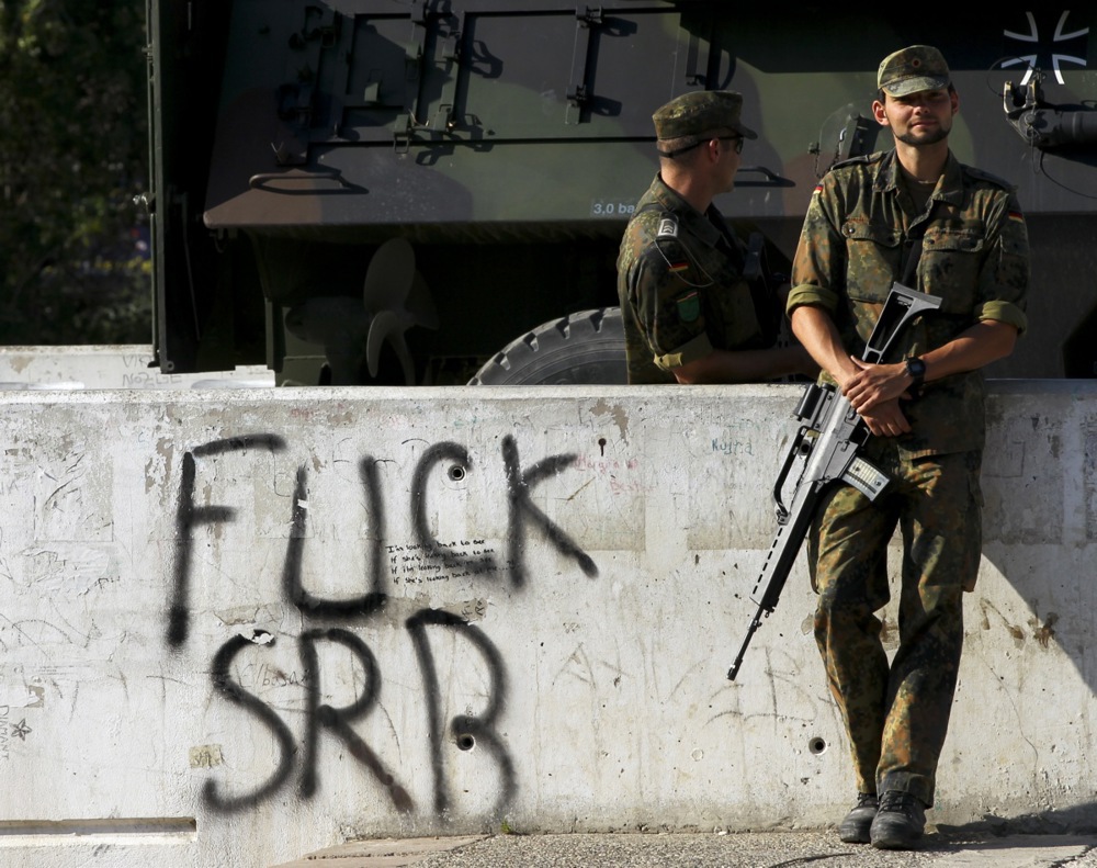 Reinforcement German NATO peacekeepers arrives near the main bridge of the ethnically divided town of Mitrovica.